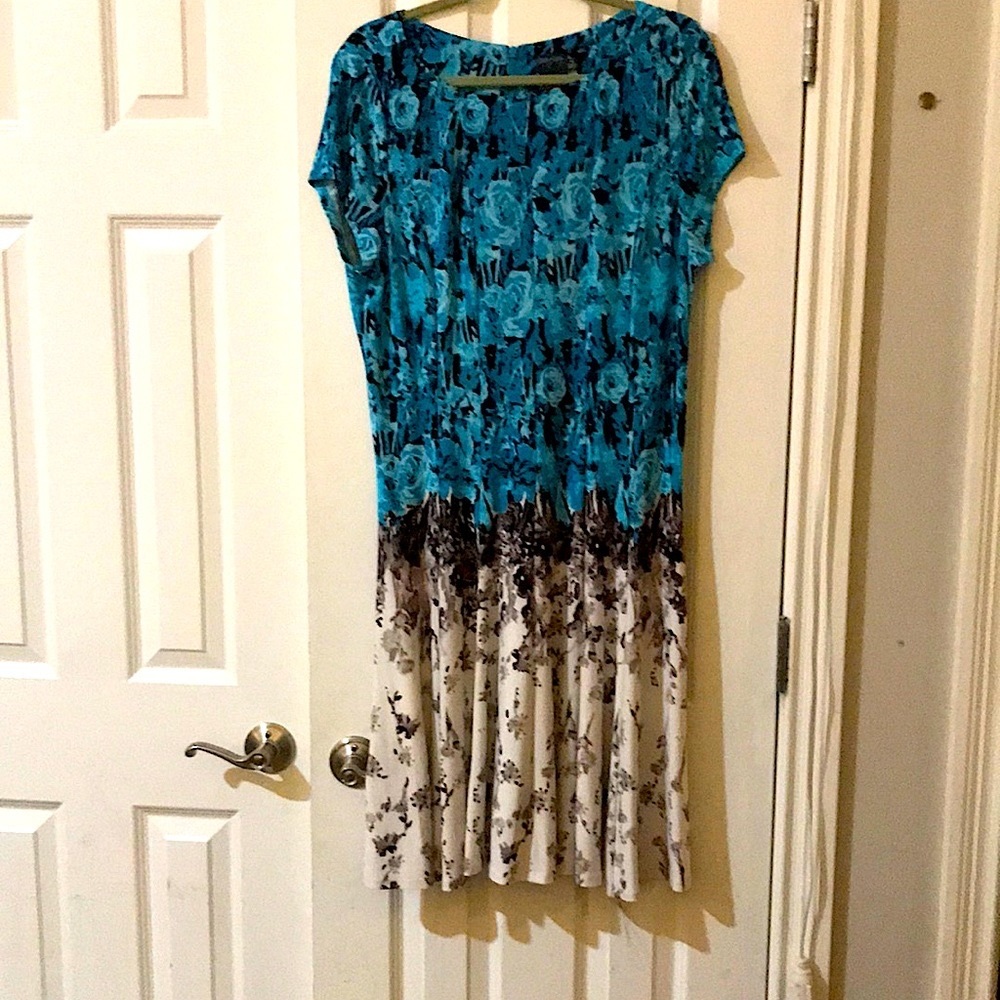 Short sleeved, knee length dress with flared skirt.